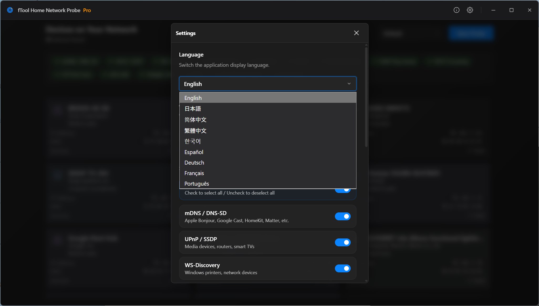 El cuadro de configuración en el tema oscuro con la lista de idiomas abierta: inglés, japonés, chino simplificado, chino tradicional, coreano, español, alemán, francés y portugués